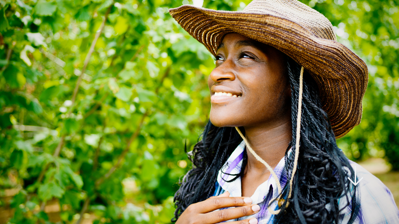 A woman farmer from XP Impact's East African network in her field